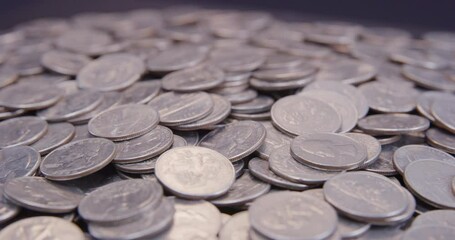 US Quarter coins rotating on turntable close up macro