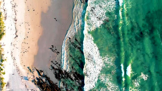 Aerial view from a drone capturing the stunning coastal meeting point of land and sea