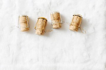 Set of wine cork from sparkling wine on white fur background, copy space, bottle stoppers top view wooden champagne corks with mushelets. Happy New Year concept, xmas, Christmas holidays photo.