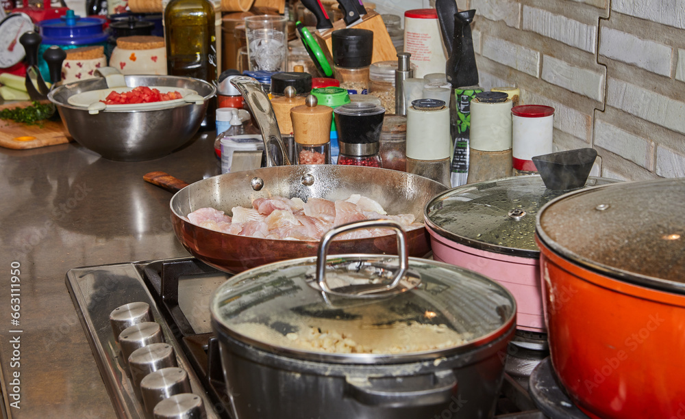 Poster Pots with cooking food in the kitchen on gas stove