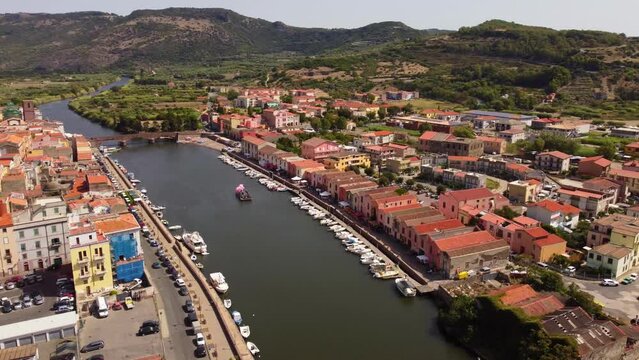 Establishing aerial shot of Bosa small town with picturesque houses facing river