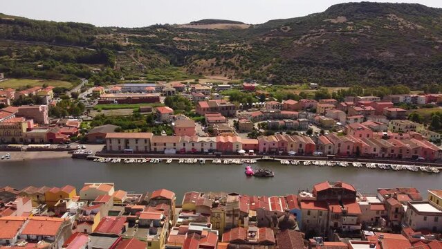 Amazing aerial view of colorful houses in Bosa by the river Temo, sideways