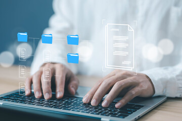 businessman manages data on a laptop, a concept Enterprise Resource Planning system or ERP, software for management recorded in a Database. Business paperless document files digital and electronic.