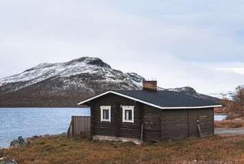 Wooden house on the coast of lake in Finland, Lapland