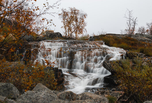 Autumn landscape with a waterfall in the Finland, Lapland
