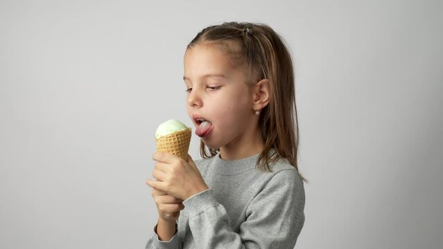 Cute little girl enjoys a delicious ice cream cone