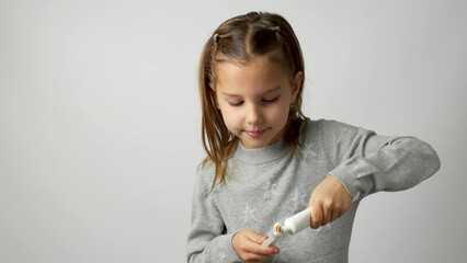 Child brushing teeth with smile, white background
