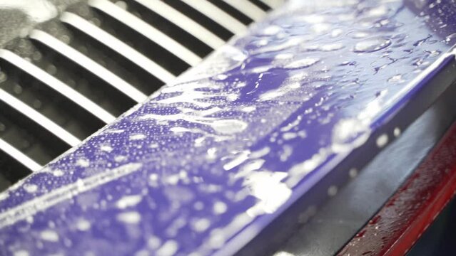 Installation of a protective paint and varnish transparent film on the car. PPF polyurethane film to protect the car paint from stones and scratches. Car detailing. 