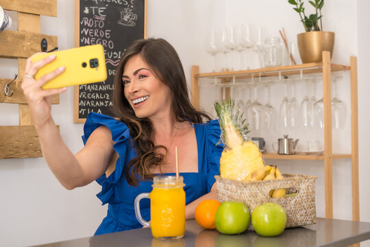Woman taking a selfie in a cafeteria