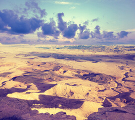 View of mountain valley. Desert with cloudy sky. Makhtesh Ramon Crater in Negev desert, Israel