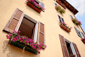 Fototapeta na wymiar Travel by Italy. Facade of old house with flowers.