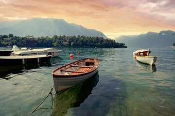 Beautiful scene of boats on lake Como in Italy. A big blue lake surrounded by green hills