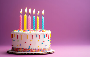 Birthday cake with candles on magenta background
