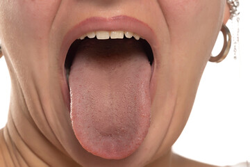 Close-up of a woman's open mouth with her tongue playfully sticking out.
