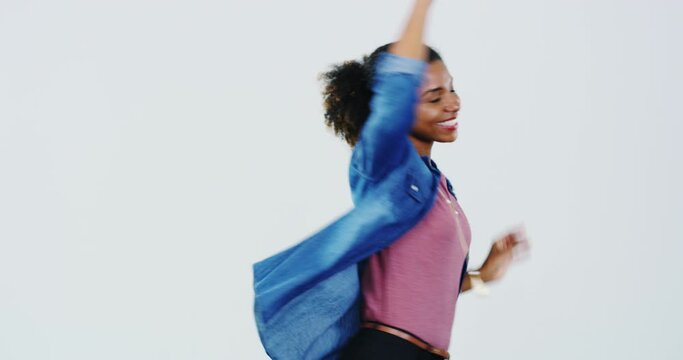 Face, smile and black woman dance for celebration in studio isolated on white background for good news, winning or success. Portrait of happy person moving with energy at disco, music party or radio