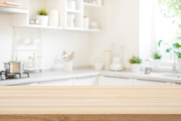 Wooden table top view for product montage over blurred kitchen interior background - obrazy, fototapety, plakaty