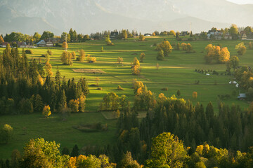 Views of rural farm fields and the Tatra Mountains from Suche, a village near Zakopane, Poland - obrazy, fototapety, plakaty