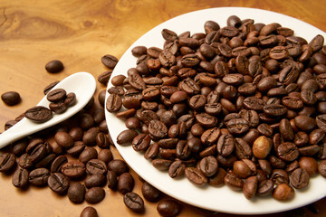 Black coffee and coffee beans on Wooden table