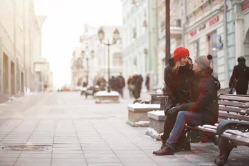  Young couple walking through the winter © alexkich