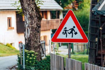School children crossing road traffic sign in alpine village in Slovenia © Bits and Splits