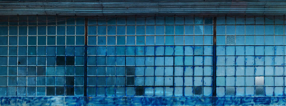 Old factory warehouse grid windows with broken glass