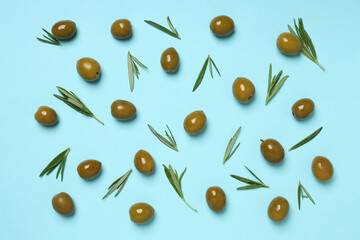 Olives with fresh leaves on a light background
