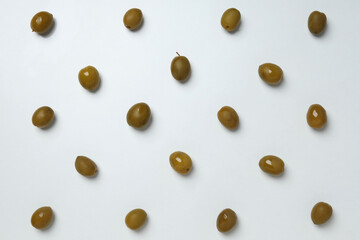 Olives with fresh leaves on a light background