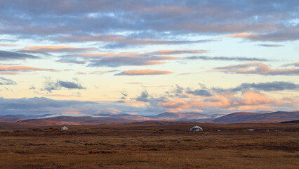 Morning panorama of the autumn tundra. Beautiful arctic landscape. Yarangi in the tundra (homes of...