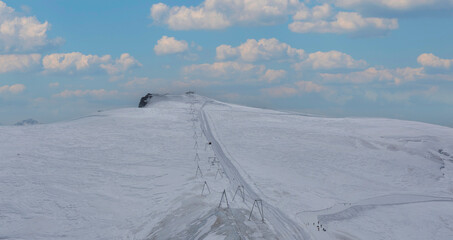 Beautiful snow with Stunning snow mountain alps shot of a ski slope and a chair lift