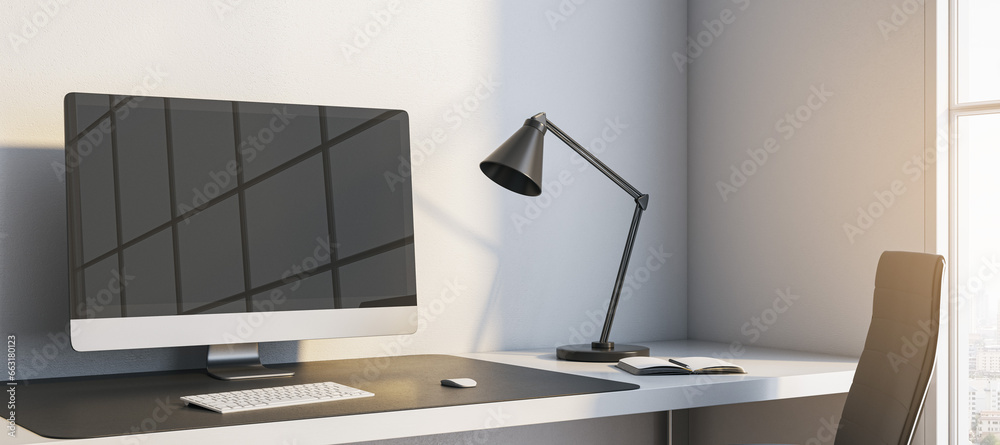 Leinwandbilder close up of modern wide workplace with reflections on computer monitor, lamp and window with city vi
