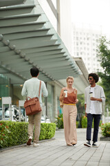 Young coworkers drinking morning coffee when hurrying to work