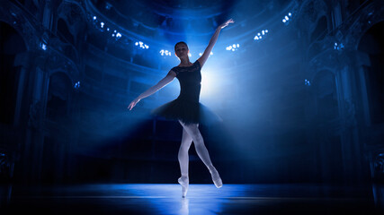 Training before performance. Young woman, elegant ballet dancer in motion, dancing on theater stage with spotlights. Concept of classical dance, art and grace, beauty, choreography, inspiration