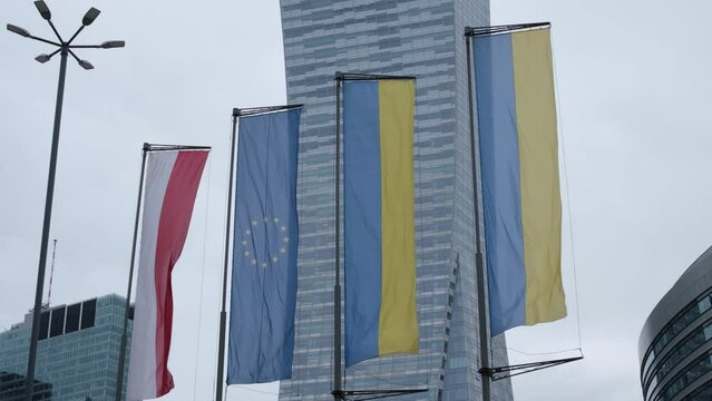 Flags of Poland, the European Union and Ukraine flutter in the wind in Warsaw. High quality 4k footage