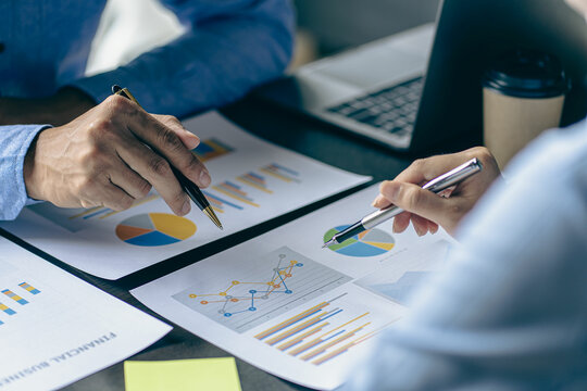 Investors, businessmen meeting to discuss stock statistics, summary graph analysis, business expense reports. and working information regarding the company's financial statements
