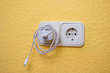 Close Up the electrical power socket and plug socket on wall.