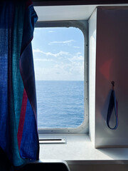 Fototapeta premium View of the sea and sky from the window of moving ferry