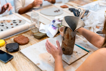 Fototapeta na wymiar Ceramic Workshop. Broken ceramic. Attempt to repair defective vase