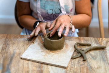 Ceramic Workshop. Close-up of a woman's hands working with clay.