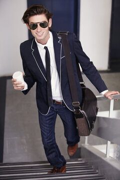 Happy, businessman and walking on stairs with coffee cup in office, fashion or graduate internship in real estate. Realtor, intern and excited for work in corporate job, workplace or drink on break
