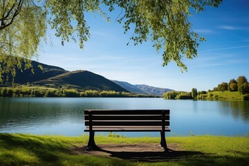 Naklejka na ściany i meble single park bench overseeing a beautiful lake