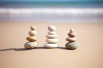 Ingelijste posters zen stones arranged in a row on sand © altitudevisual