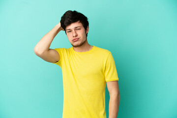 Young Russian man isolated on blue background with an expression of frustration and not understanding