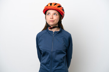 Young cyclist Lithuanian woman isolated on white background and looking up