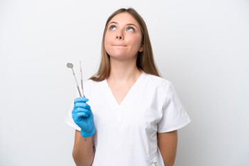 Dentist woman holding tools isolated on white background and looking up