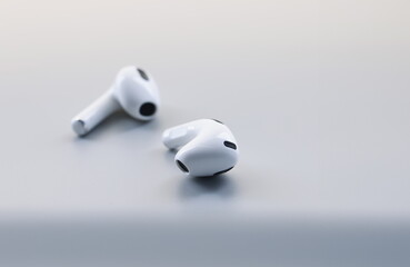 Close-up of pair of white wireless headphones on grey background, modern device to listen music or...