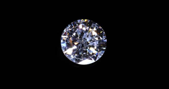 polished real diamond 57 facets, light inspection rotate. on black background.