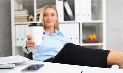 Portrait of blonde female lift hot cup of coffee drink, pause from work, cheers. Coffee break, lunch, relax, need energy, business, office life concept