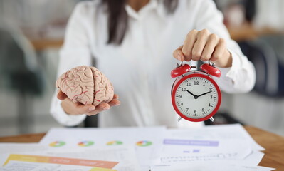 Close-up of female hold clock and brain miniature, work in progress, time to think. Creativity, smart, idea, startup, timing, business, brainstorm concept