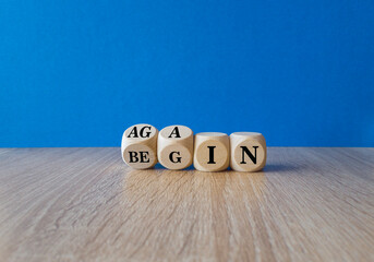 Begin again symbol. Turned wooden cubes and changes the words begin to again. Beautiful blue...