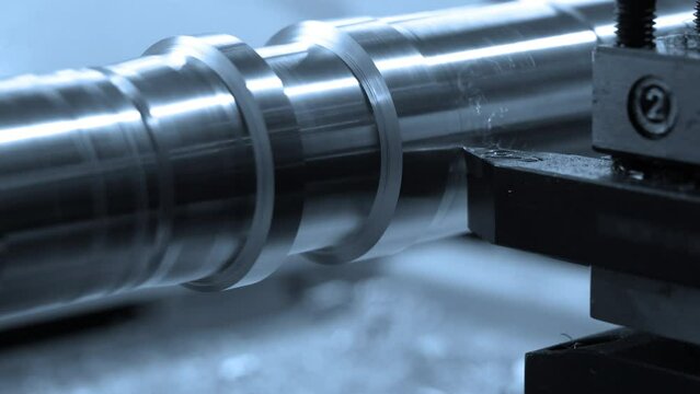 Precision machining and turning of a steel rod on a CNC lathe, modern lathe for metal processing